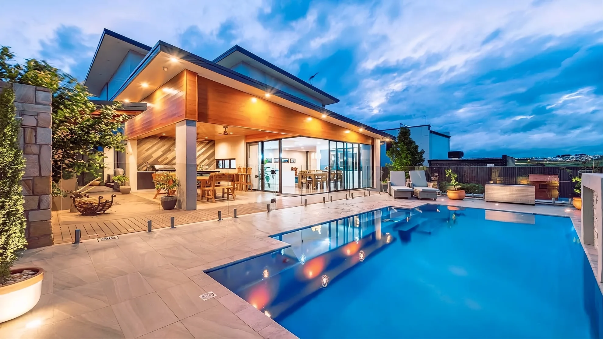 Modern backyard with a fiberglass pool and spa at golden hour