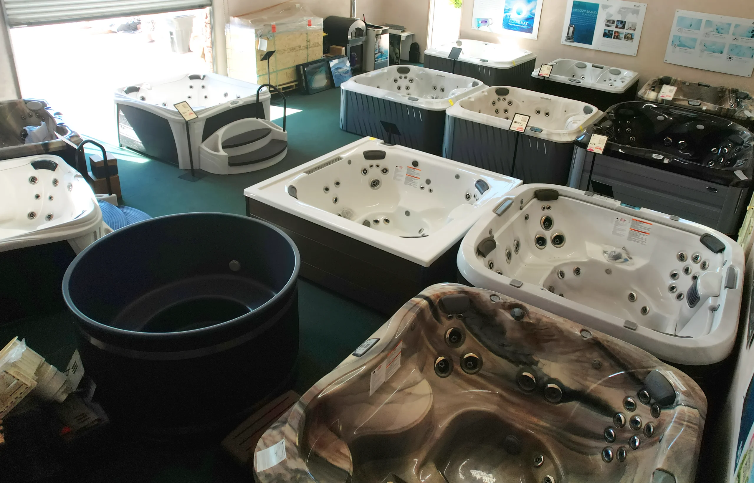 Hot tubs and swim spas lined up in stock at the Renaissance Pools & Spas Henderson location