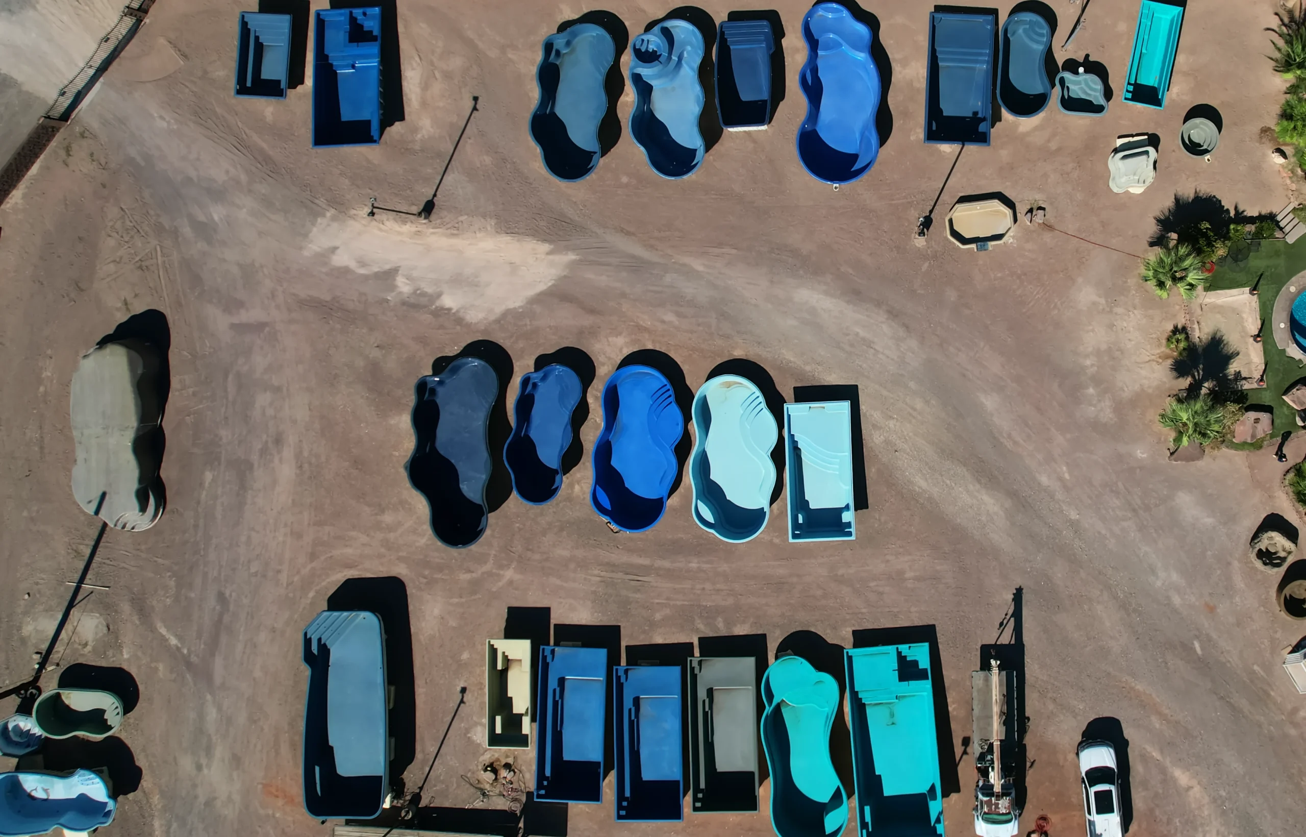 Rows of real fiberglass pool shells lined up in the Renaissance Pools & Spas yard
